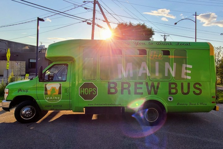 a green truck parked in a parking lot