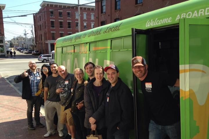 a group of people standing in front of a bus