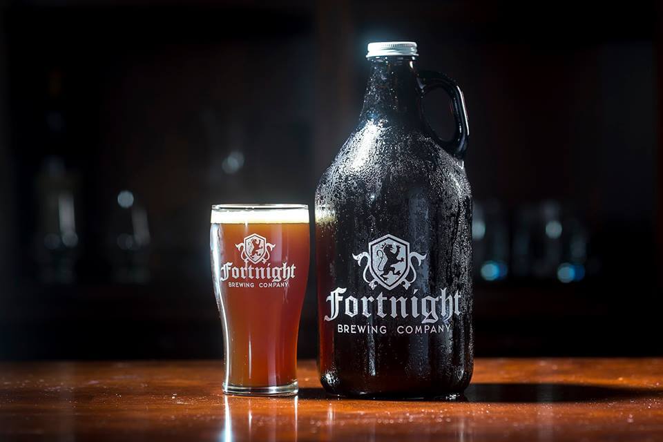 a bottle and a glass of beer on a table