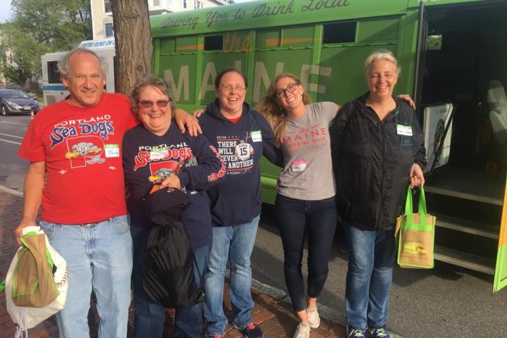 a group of people standing in front of a bus