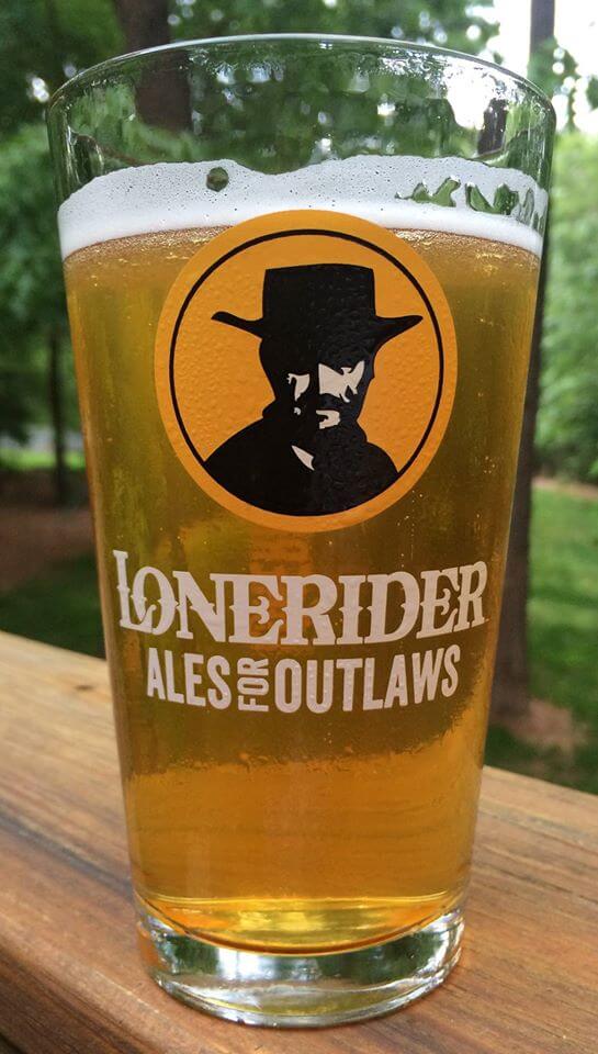 a close up of a bottle and a glass of beer on a table