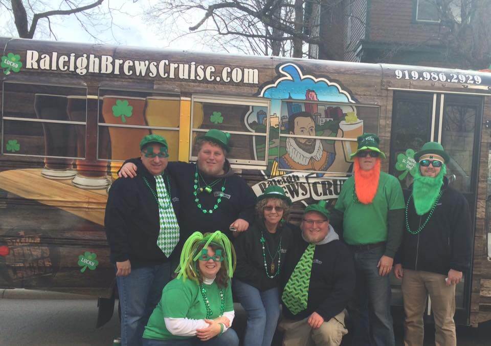 a group of people standing in front of a bus