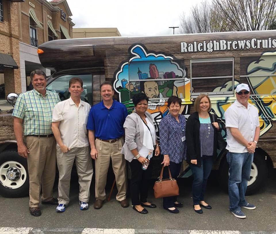 a group of people standing in front of a crowd posing for the camera