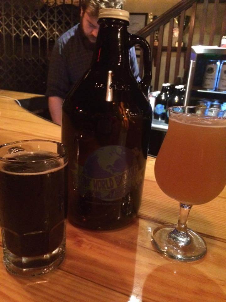 a bottle of wine and a glass of beer on a table