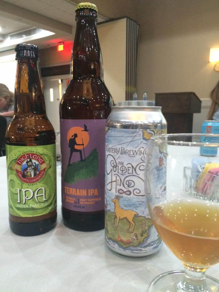 a bottle of wine and a glass of beer on a table