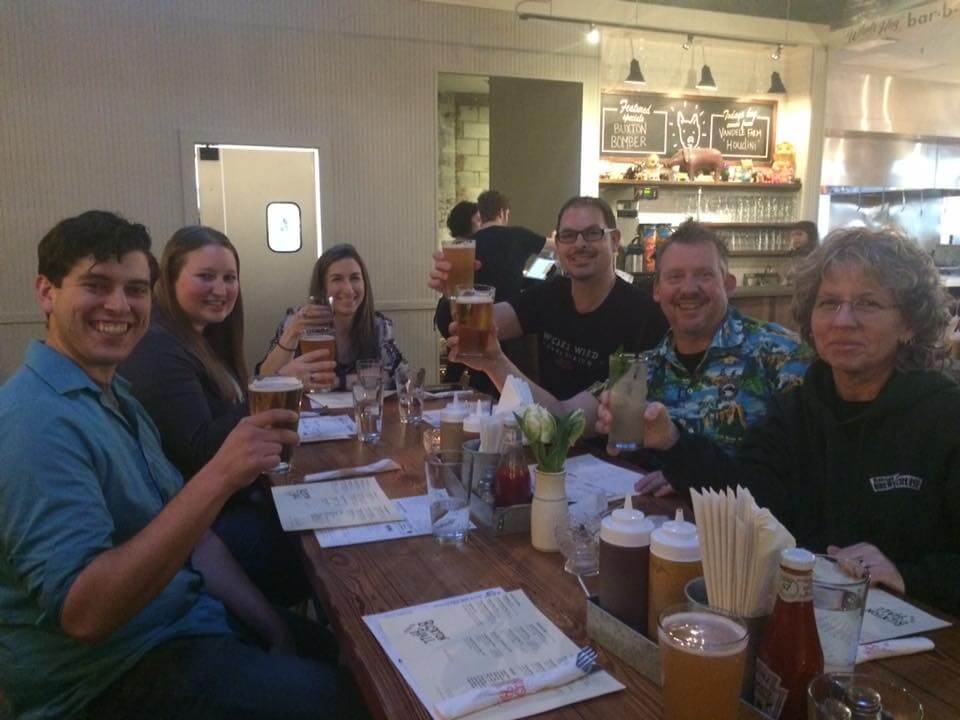 a group of people sitting at a table with wine glasses