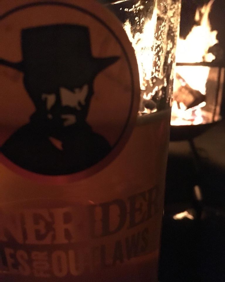 a close up of a bottle and a glass of beer