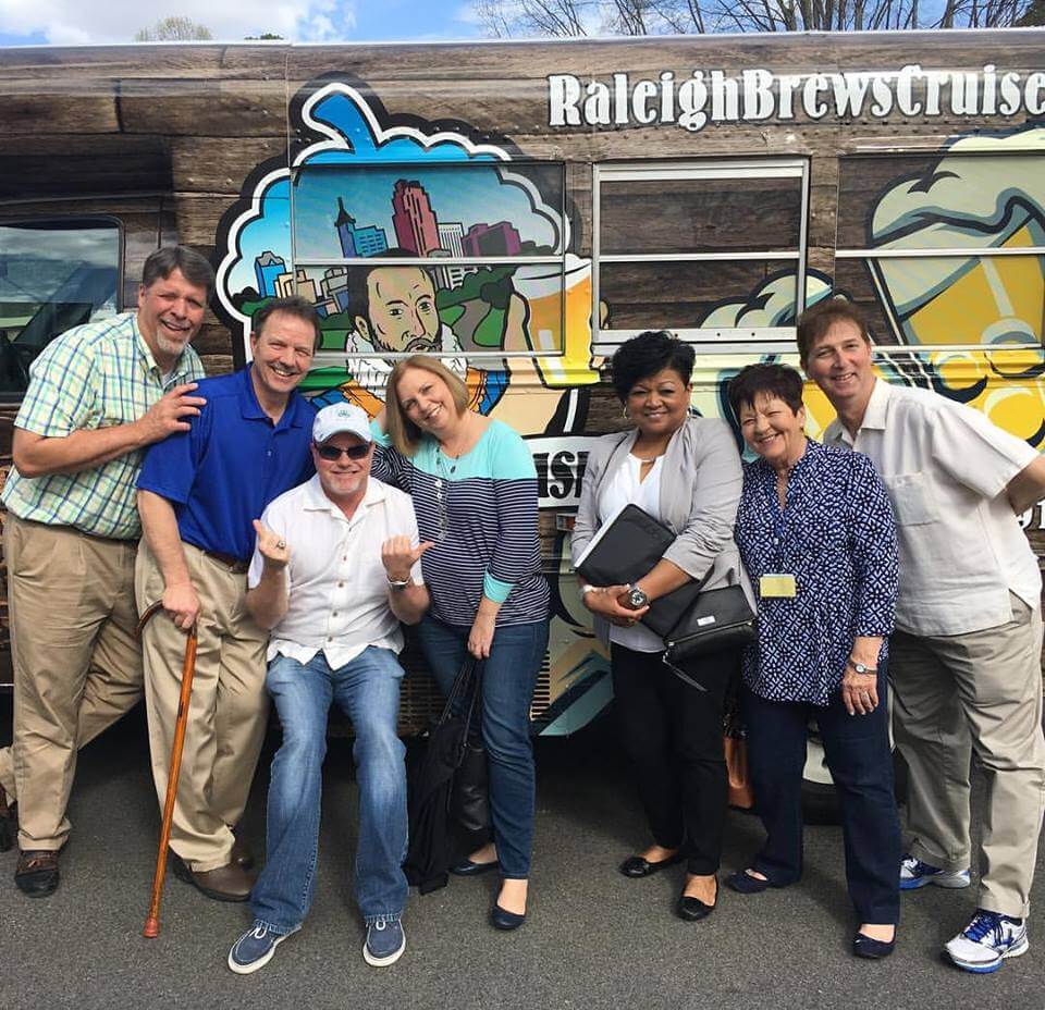 a group of people standing in front of a crowd posing for the camera