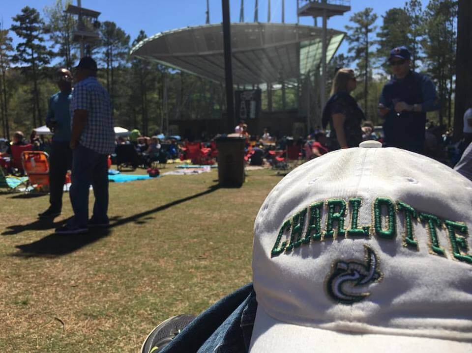 a person that is sitting in the grass