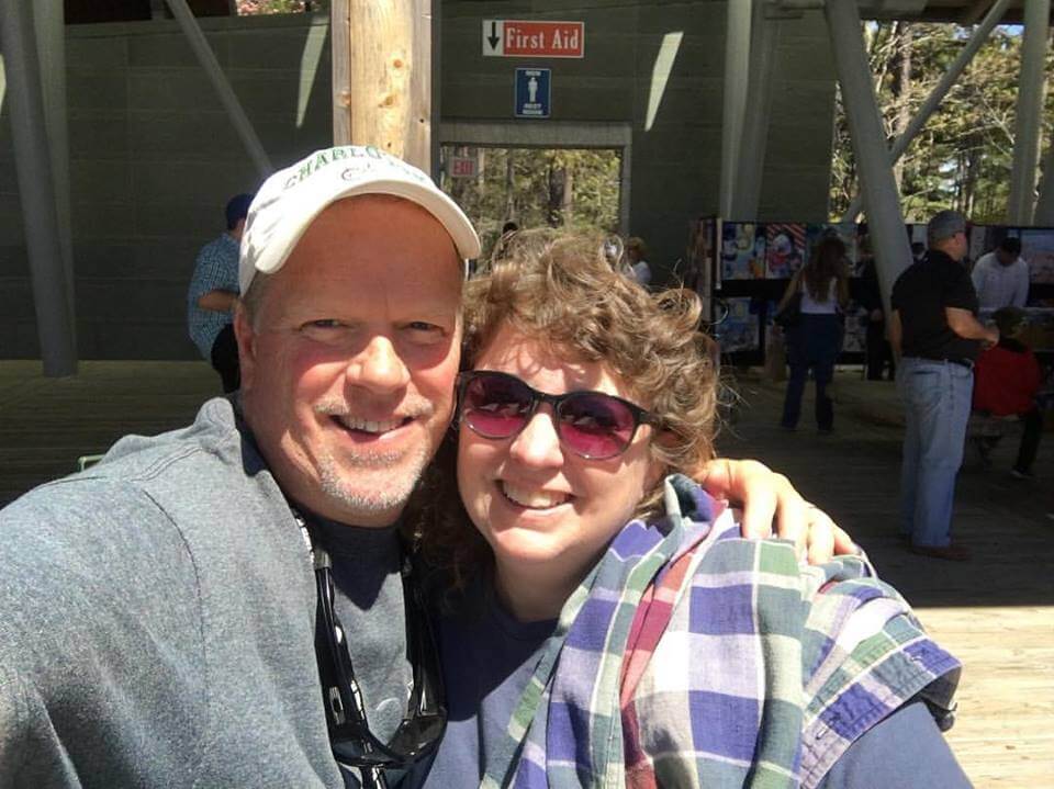 a man and a woman smiling for the camera