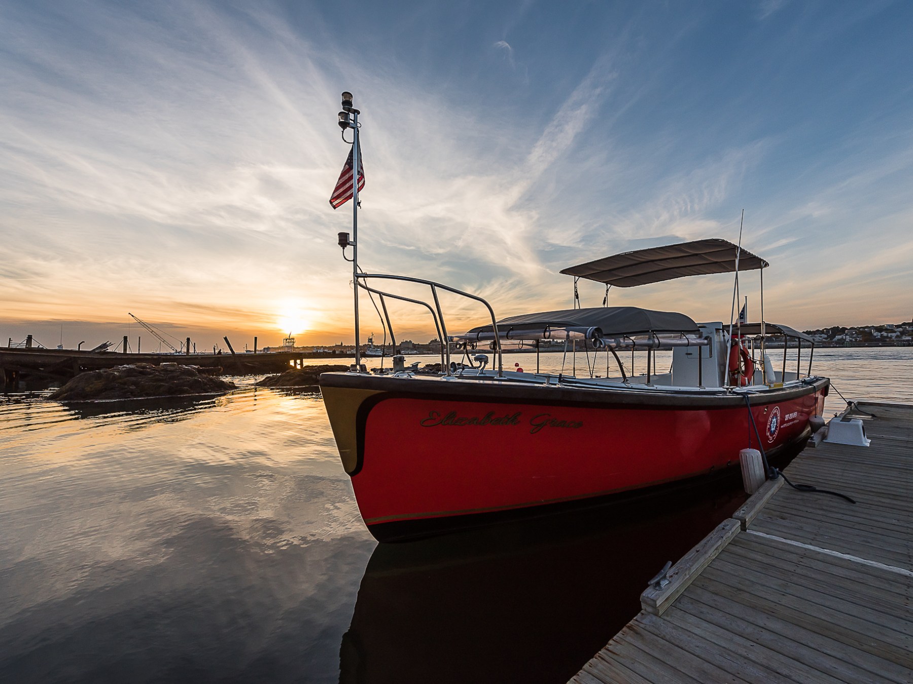 a boat is docked next to a body of water