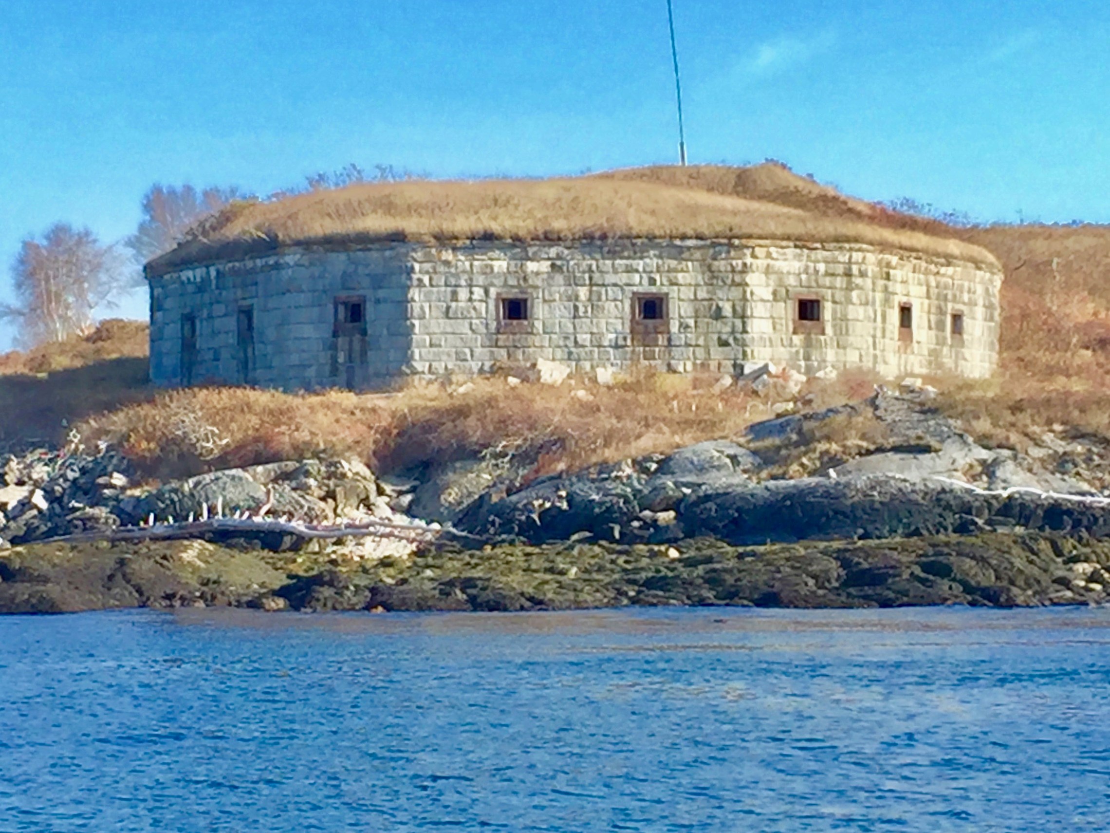 a castle with water in front of a brick building