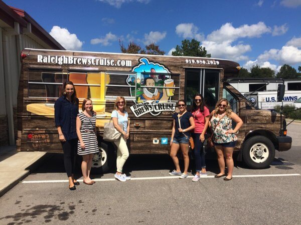 a group of people standing in front of a bus