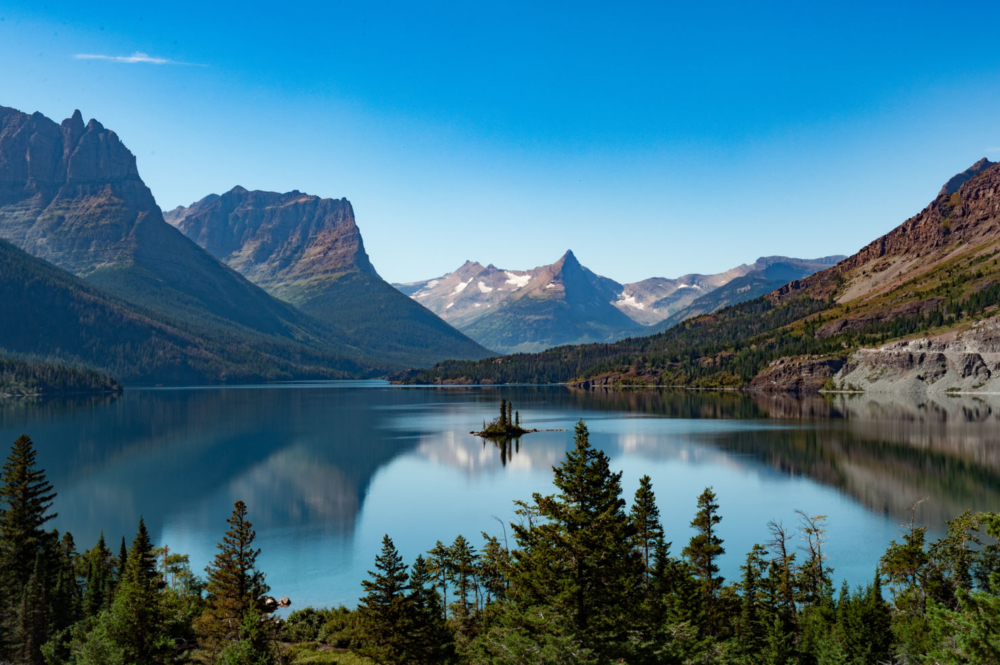big sky brews cruise a body of water with a mountain in the background