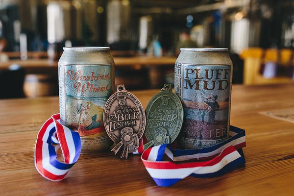 a cup of coffee sitting on top of a wooden table