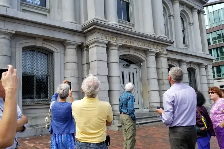 a group of people standing in front of a building