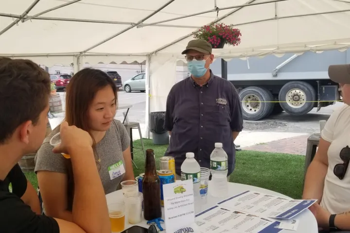 a group of people sitting at a table with wine glasses
