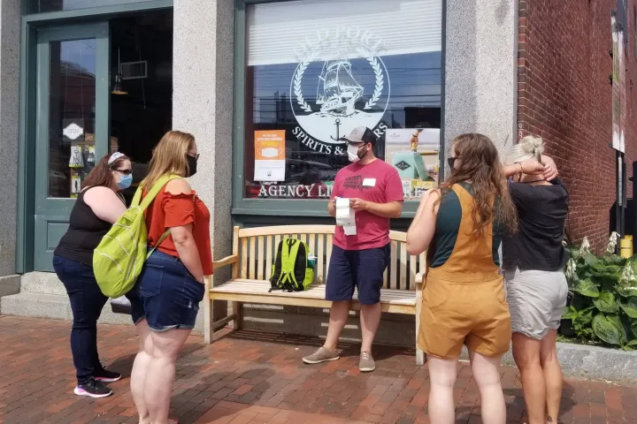 a group of people on a sidewalk