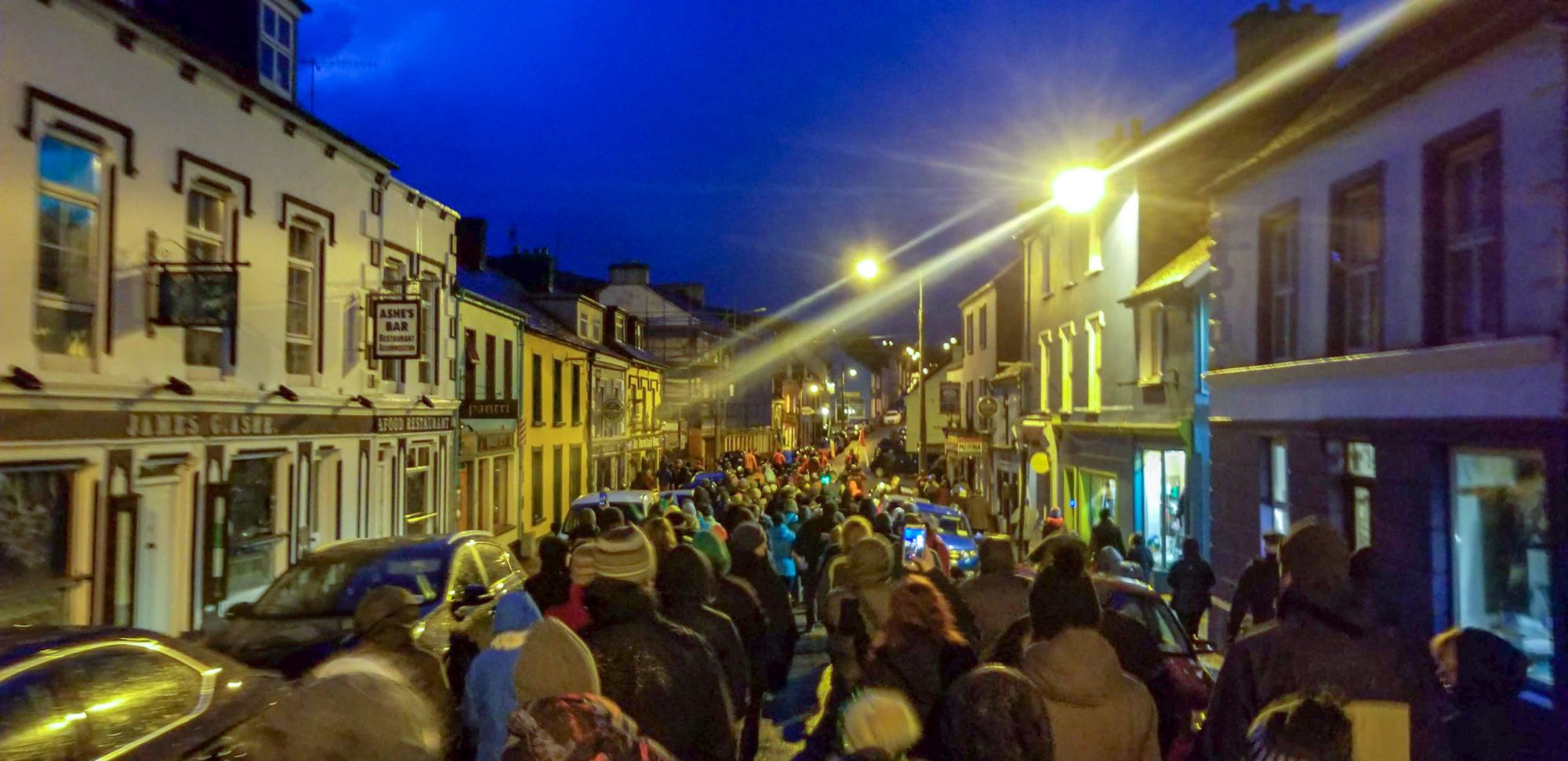 a crowd of people standing in front of a building
