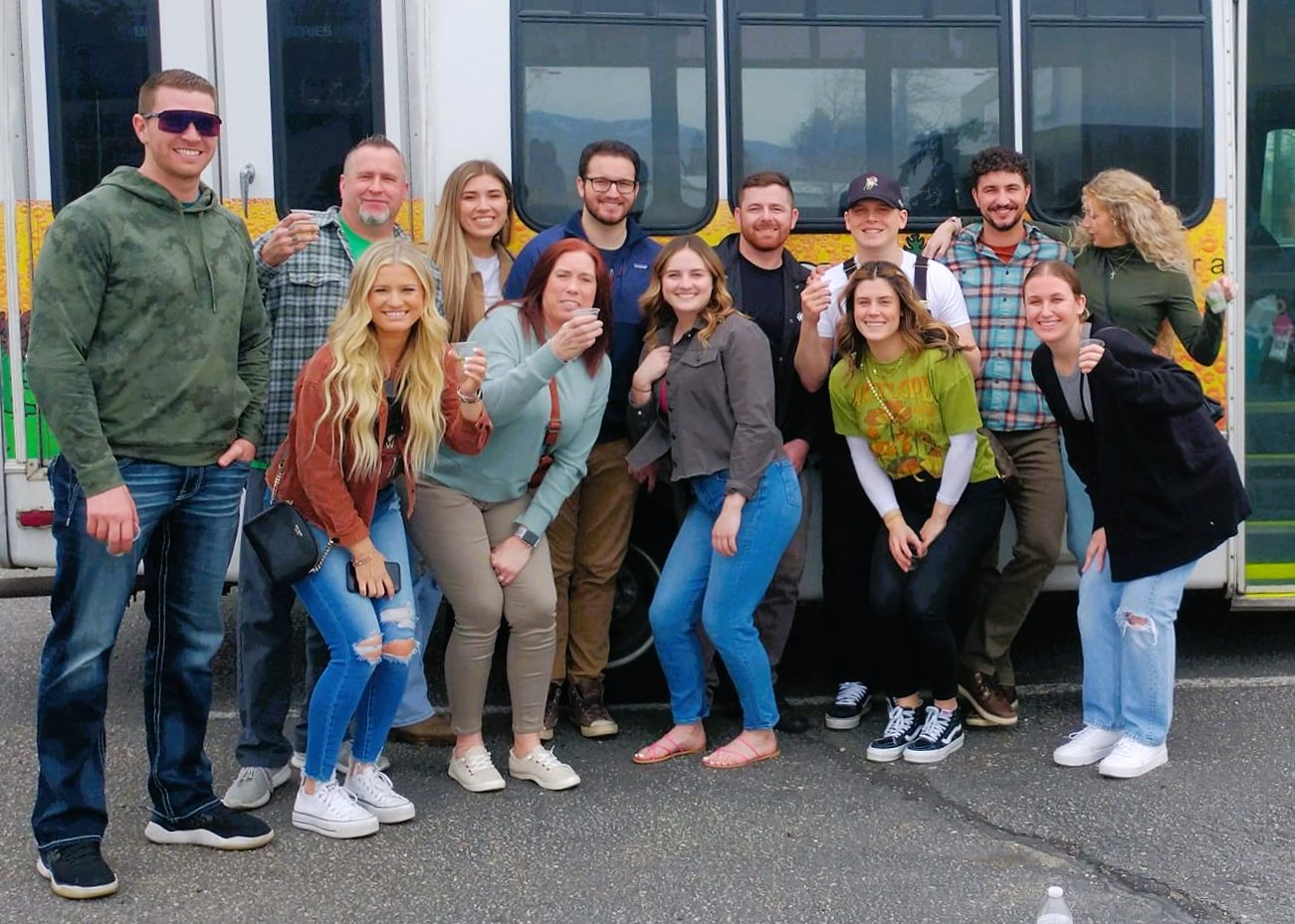 276128723_5099807346738682_1792255807370847640_n a group of people standing in front of a bus