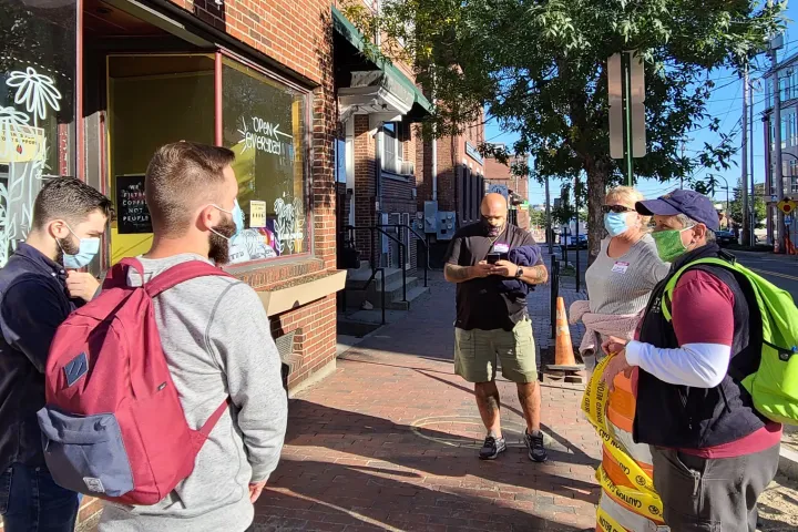 a couple of people that are standing in the street