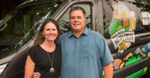a man standing in front of a car posing for the camera