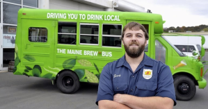 a man standing in front of a green truck