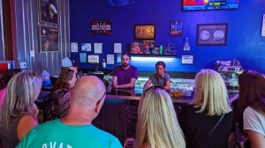 a group of people sitting in front of a store