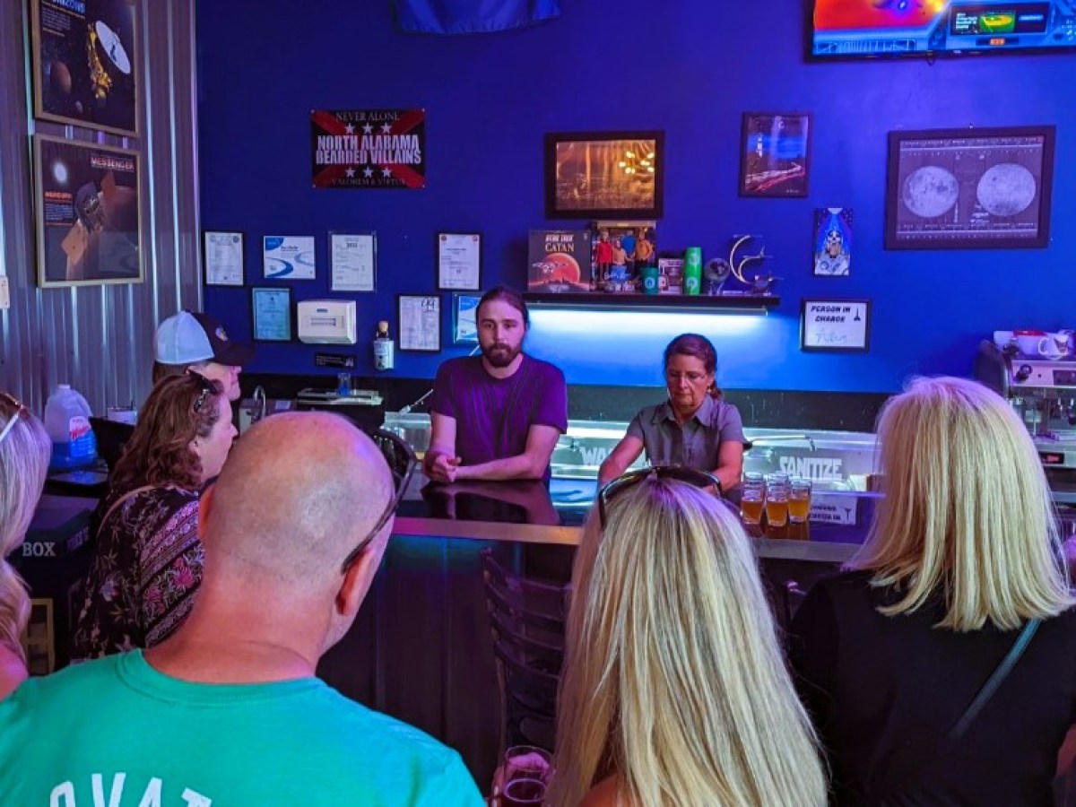 a group of people sitting in front of a store