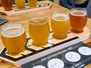 a cup of coffee and a glass of beer on a table