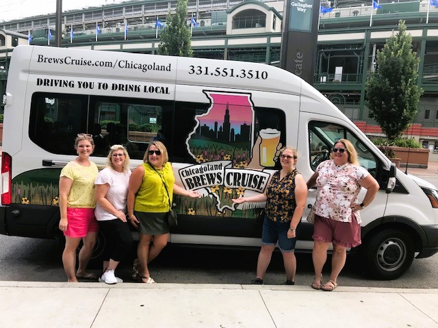 a group of people standing in front of a bus
