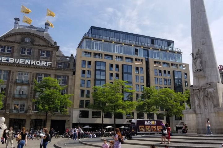 a group of people walking in front of a building