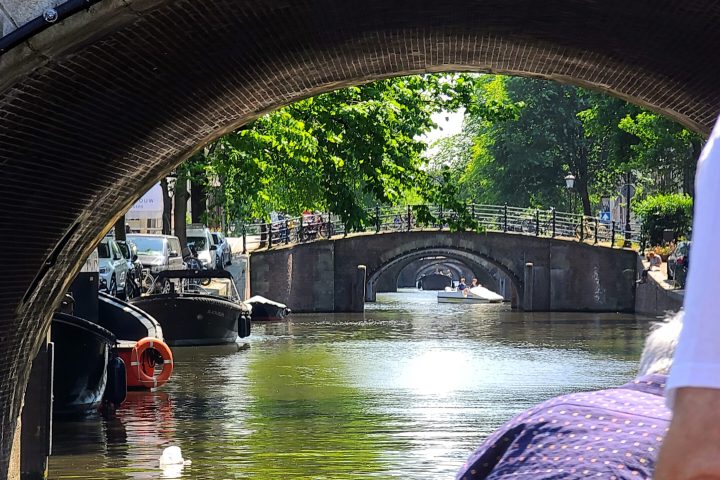 a man standing on a bridge over water