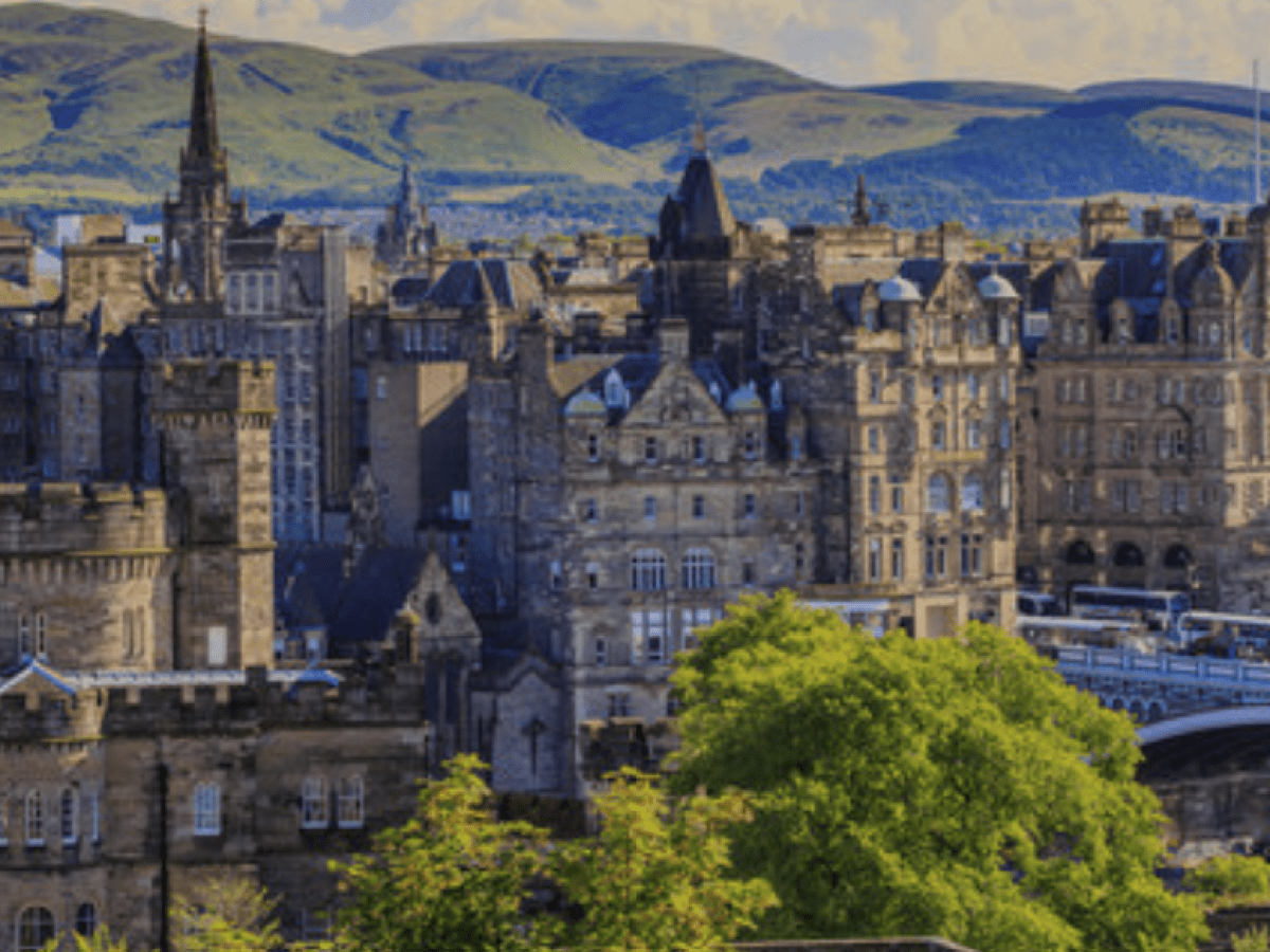 a castle like building with a mountain in the background