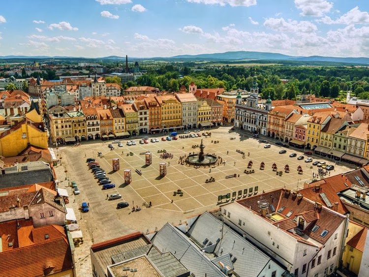 Aerial view of the Town Square in České Budějovice with surrounding buildings and a central fountain.