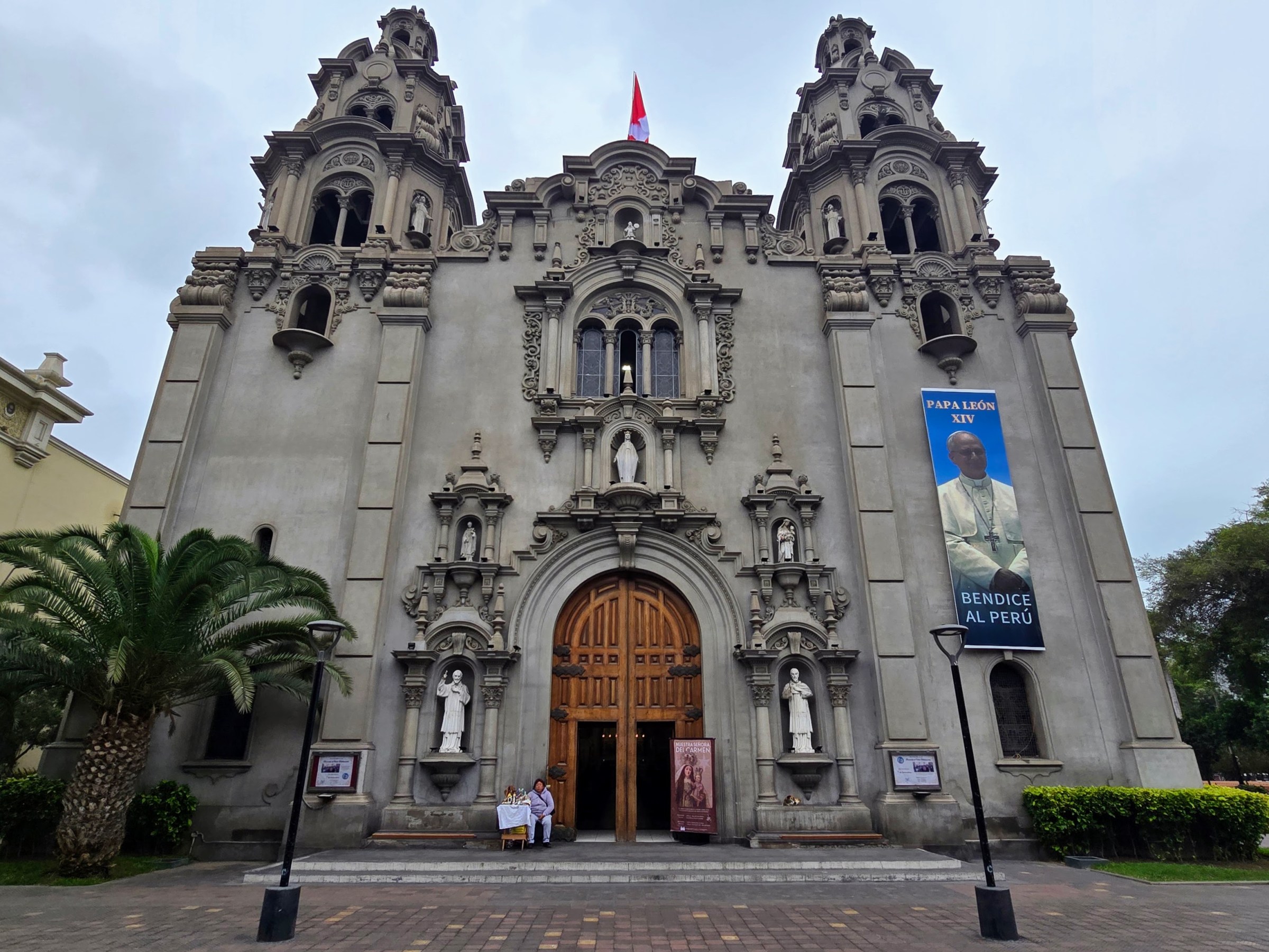 Front view of a large historic church with detailed architecture and two towers.