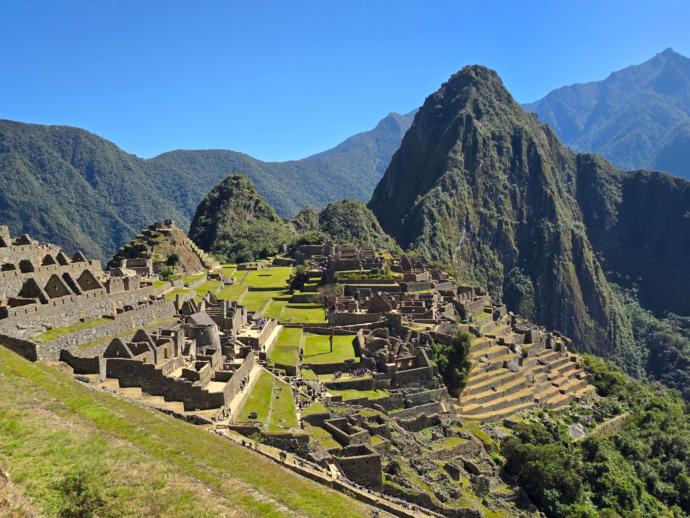 Panoramic view of Machu Picchu ruins with mountains in the background.